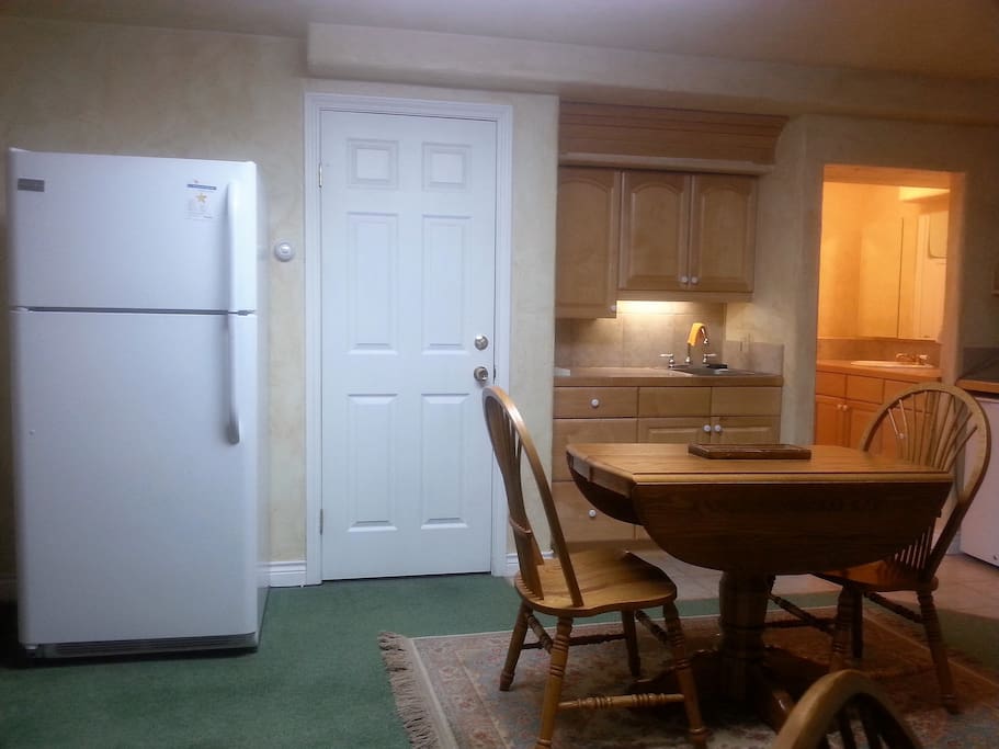 Kitchenett w/ lg refrigerator - door to laundry facility--Bathroom Sink #2