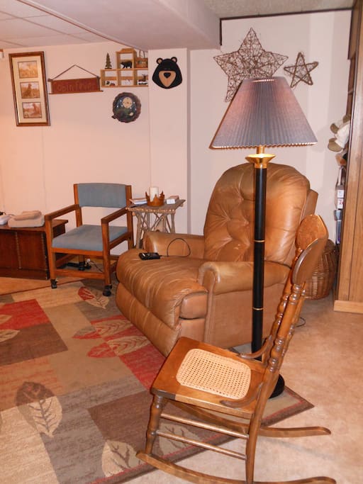 Opposite side of the bed in the bedroom is a massage/heat recliner.