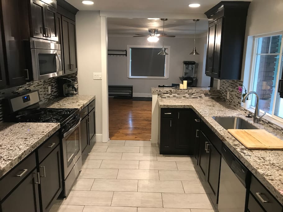 Kitchen fully loaded with dishes, cookware, and appliances.