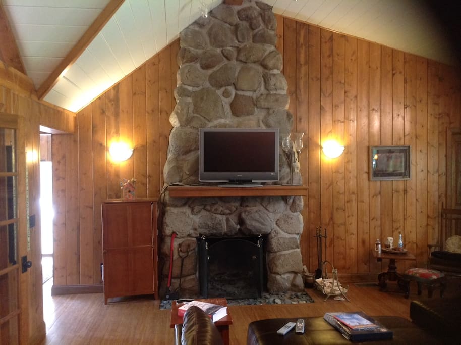 Original wood burning stone fireplace in living room