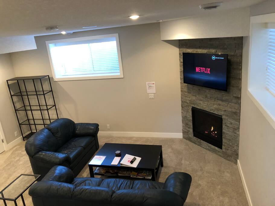 Relax in the living room area with fireplace and big screen TV