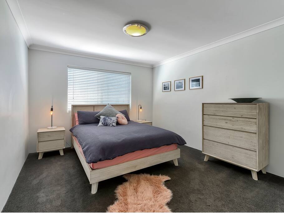 Spacious luxe master bedroom with queen bed