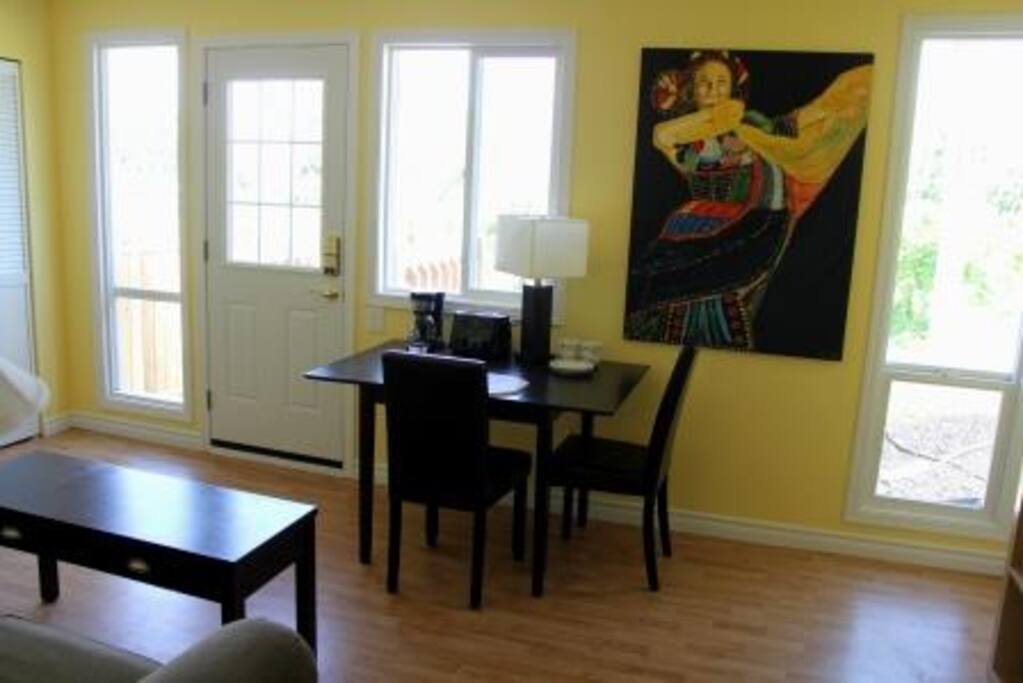 Living room showing private entrance and kitchen table