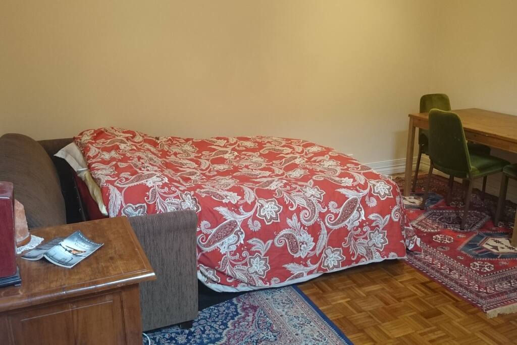 How the room looks when the couch is used as a bed. There is another bedroom to use as well.