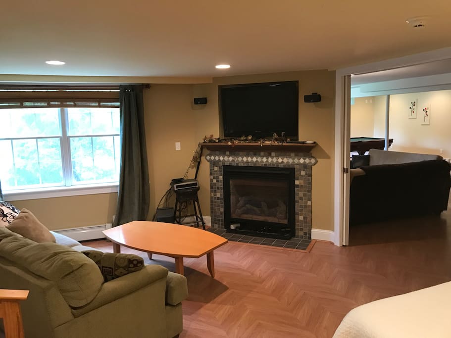 Flat screen TV above the fire place with surround sound and dish cable