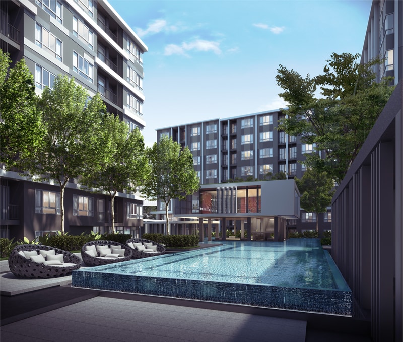 An infinity pool is set against a backdrop of sleek apartment buildings and lush greenery. Lounge chairs are positioned around the pool, inviting relaxation. The clear blue sky reflects on the water's surface, creating a serene atmosphere in the landscaped outdoor area.