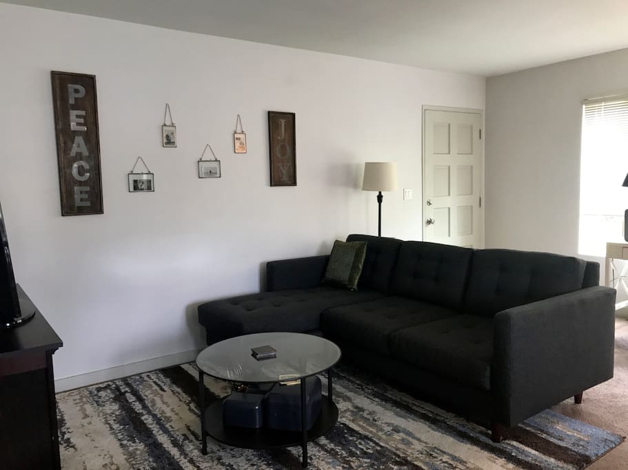 Living room with comfortable couch (room for one to sleep), HD Smart TV with Netflix, Hulu and HBO GO.