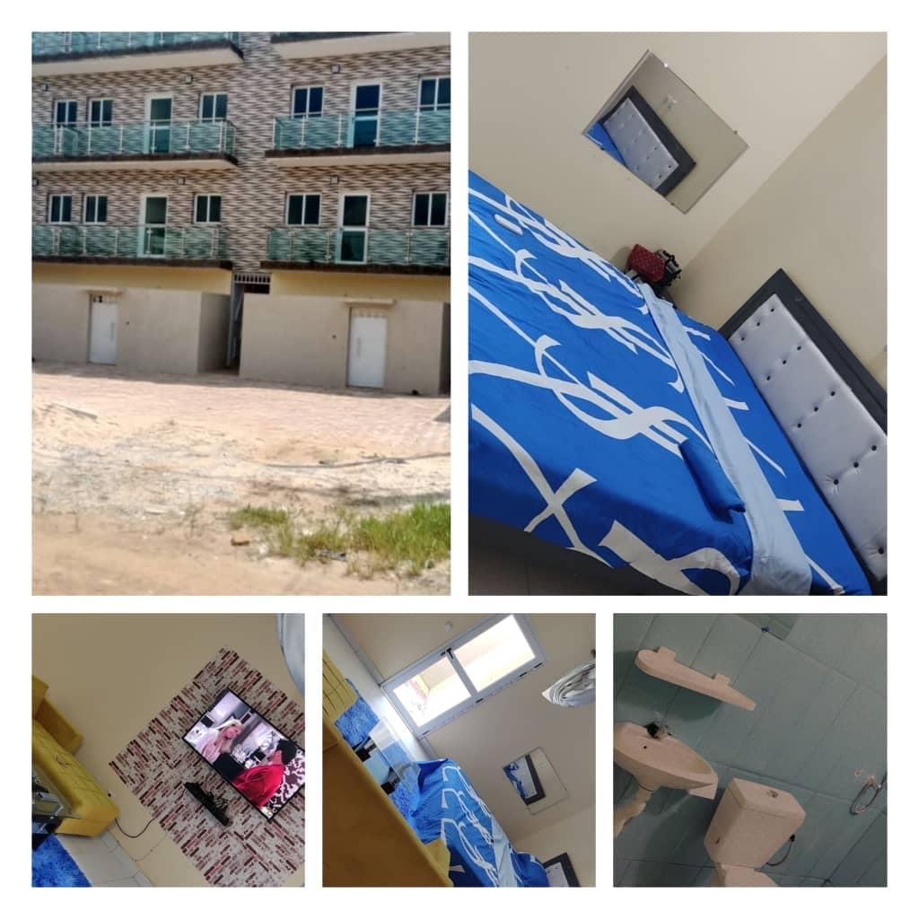 A modern multi-story building features multiple balconies and a light exterior. A cozy sleeping area displays a spacious blue bedspread and a mirror on the wall. The living space includes a television and various furnishings, while a bathroom area is equipped with essential fixtures.