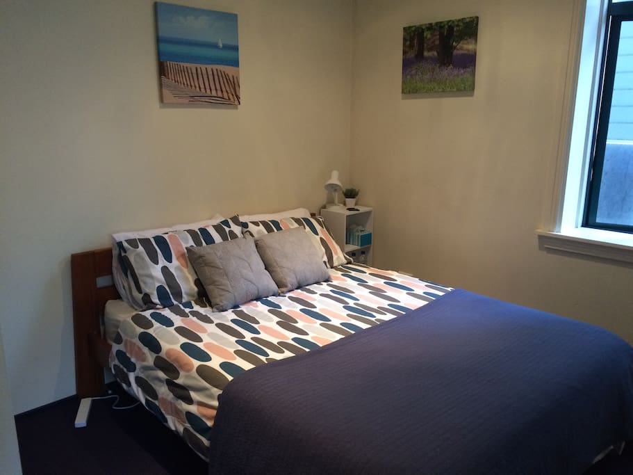 2nd bedroom has a queen bed, wardrobe, windows