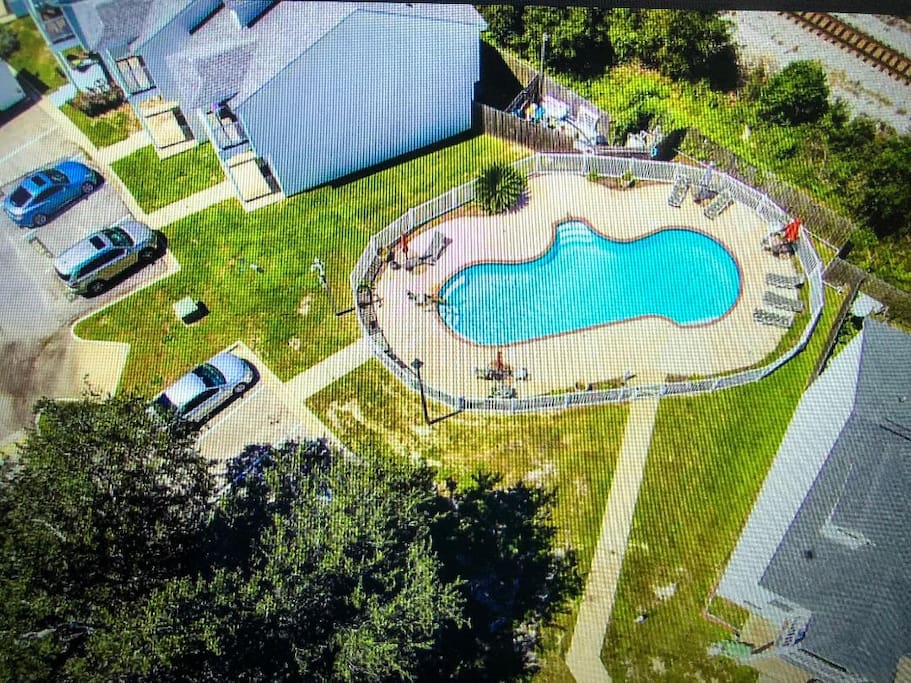 Air view of our private pool on property, new lawn furniture, tables with umbrellas, always kept VERY clean our unit is just about 8 doors from pool