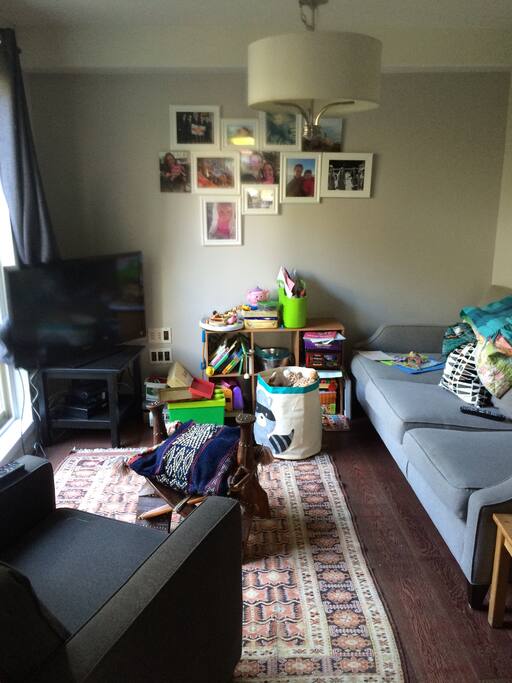 Den with tv sofa and children's toys (toddler and infant) door to fully enclosed back patio
