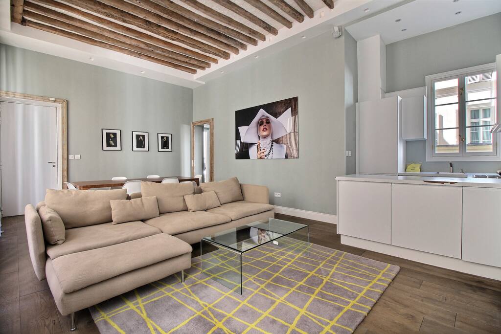 Luminous living room with dining area, sofa and TV