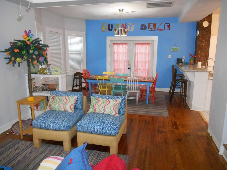 Colorful, casual seating with open plan for living, dining and kitchen.
