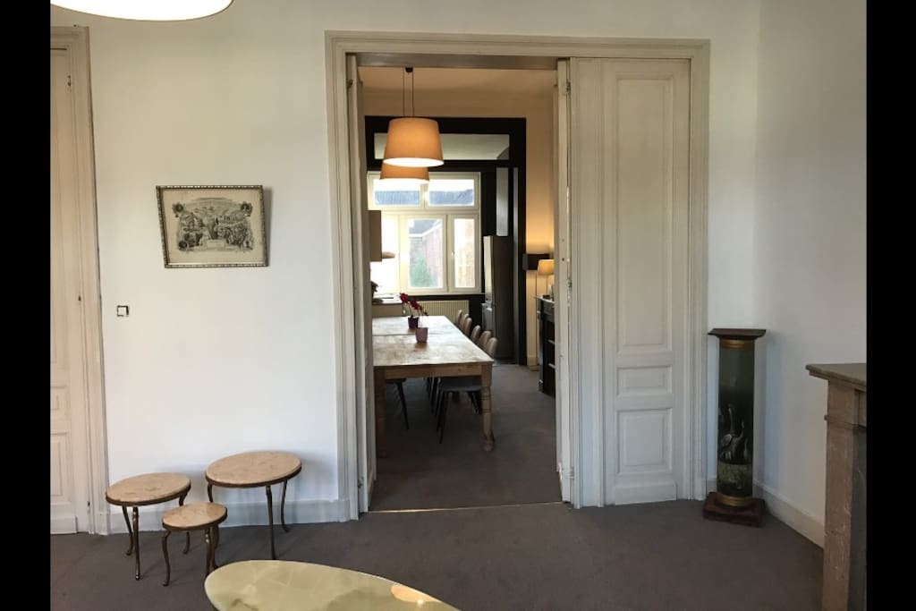 View from the first living room to the dining room and to the kitchen... The decoration is based on a mix between antiques, old frames, ... All old wooden doors and ceilings have been made in 1893, when the house was built!