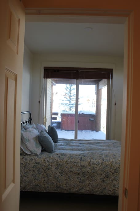Queen bedroom with private access to hot tub. Private bathroom