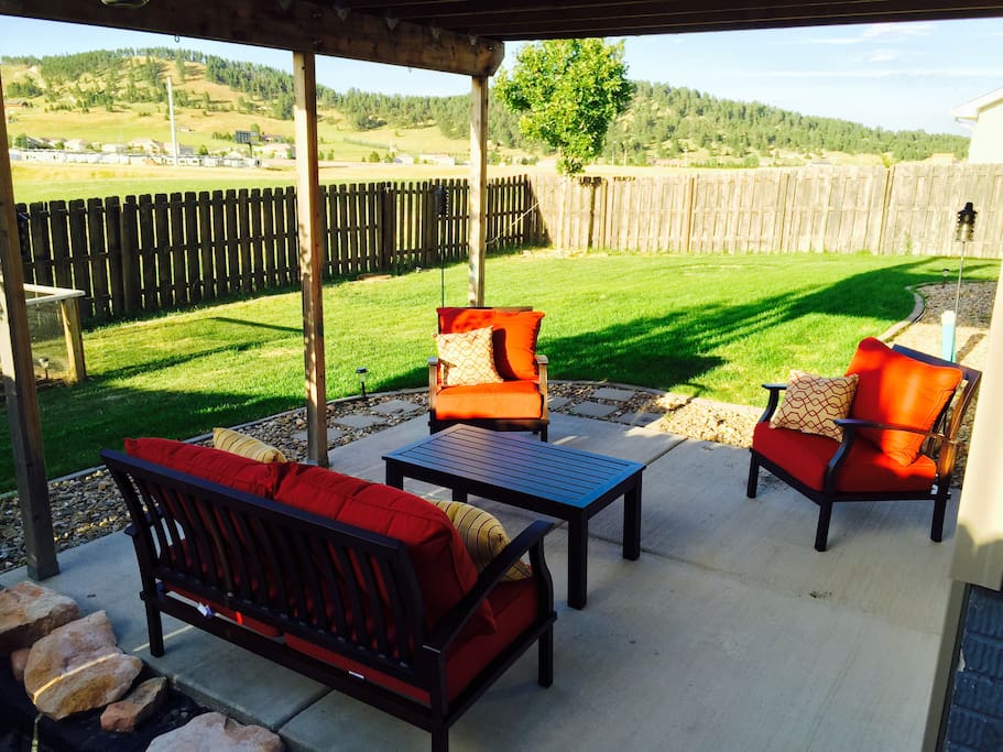 Comfortable patio furniture and views of the hills on a summer night