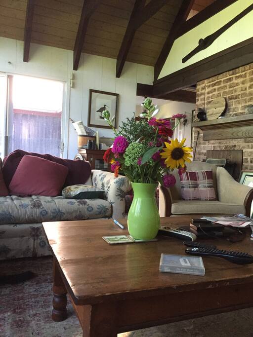 The living room enjoys big picture windows with a view of the creek