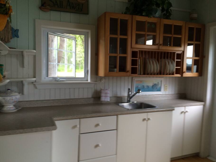 Kitchen fully equipped with full sized fridge and stove, dishes, pots and pans, utensils. Spices included but nothing else.
