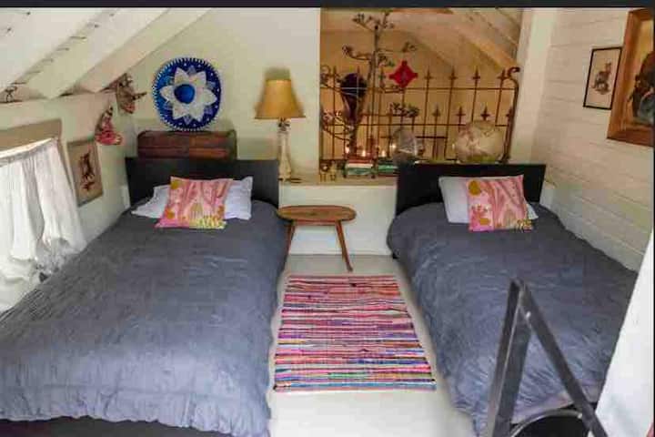Loft above dining room with two cozy twins and attached balcony