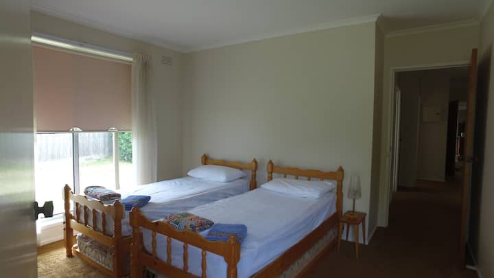 Bedroom 4 has 2 single beds, walk through robe and a small ensuite 