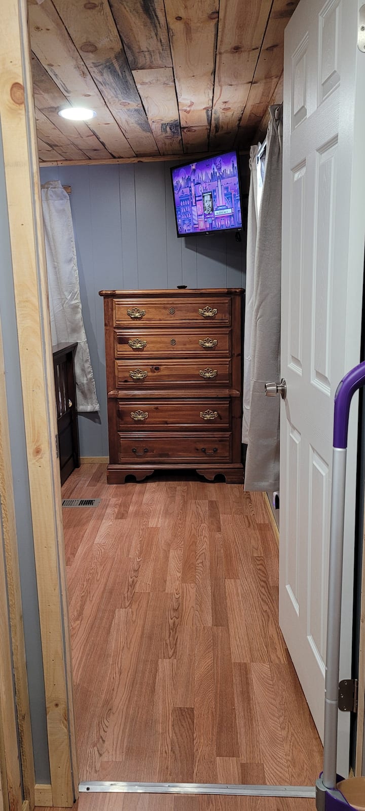 Entrance of back bedroom which includes a dresser and a twin size trundle bed with an additional twin mattress pull out. 