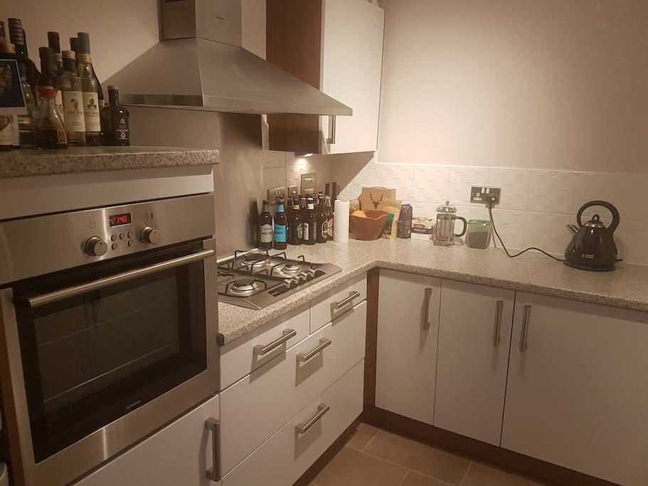Well-equipped kitchen with fan oven and dishwasher.