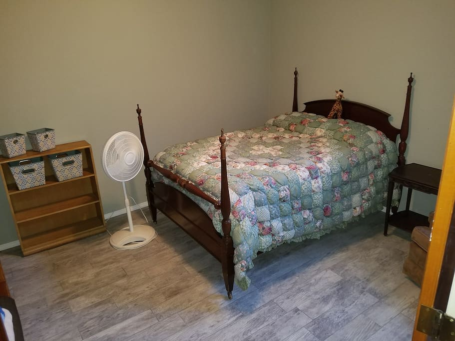 Full size bed, comfortable large room, with tile floor.