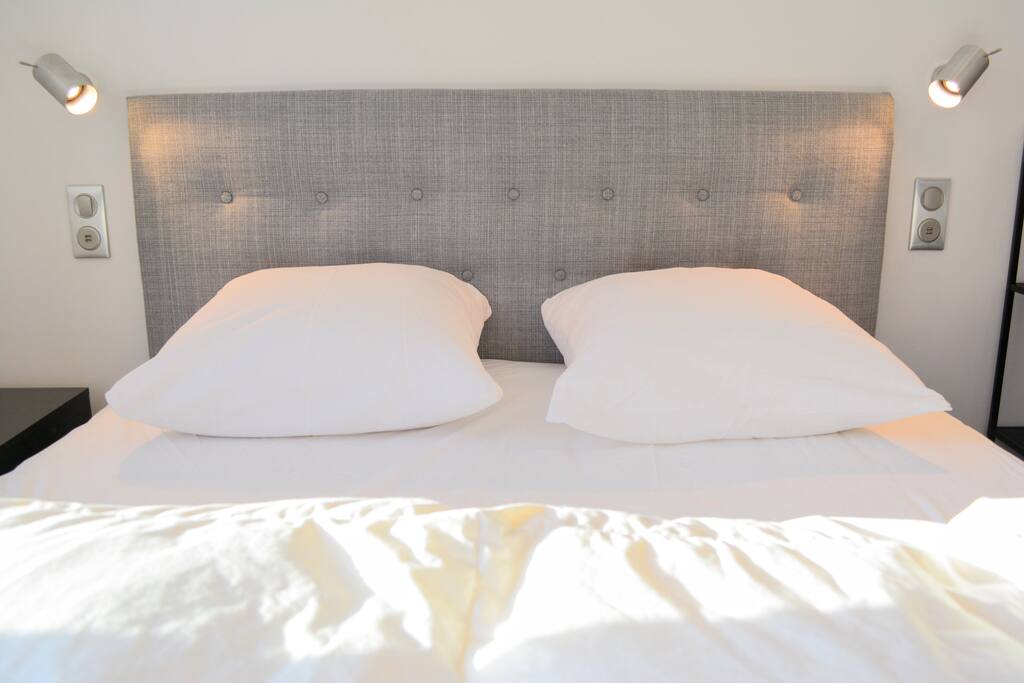 Large, plush, modern bed with reading lights and USB charging ports!