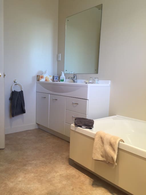 Private bathroom with bath & shower cabinet, separate toilet.