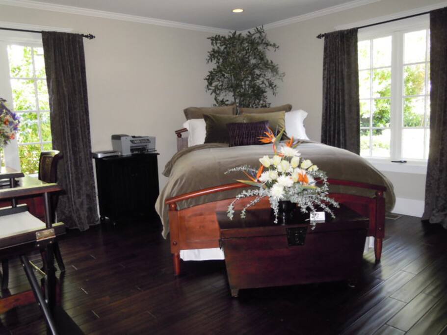 first level bedroom with queen size bed and desk