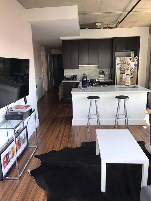 Spacious, light-filled communal living area with flatscreen TV, cable and brand new sectional couch.