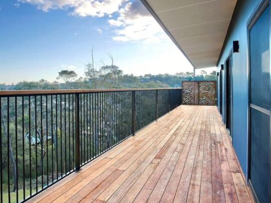 Huge deck hugs all bedrooms and living spaces