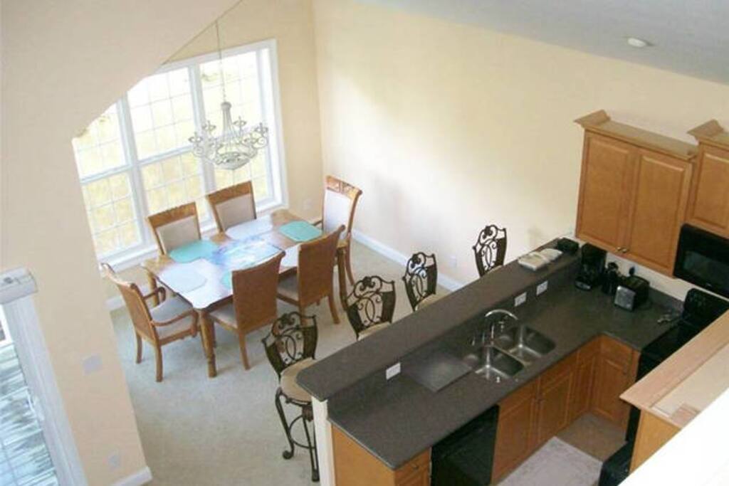 View of upstairs dining/kitchen area looking down from third floor