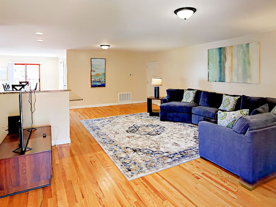 A plush sectional and hardwood floors vitalize the living room