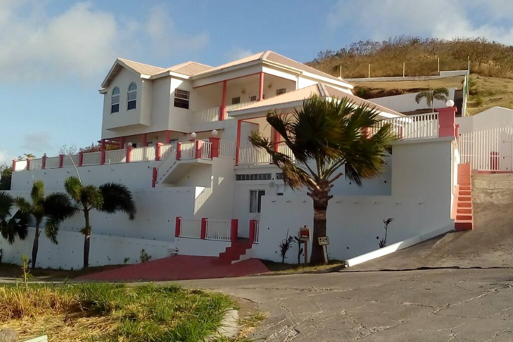 The house is located on top of a hill overlooking Frigate Bay, the Marriott Hotel and its golf course.