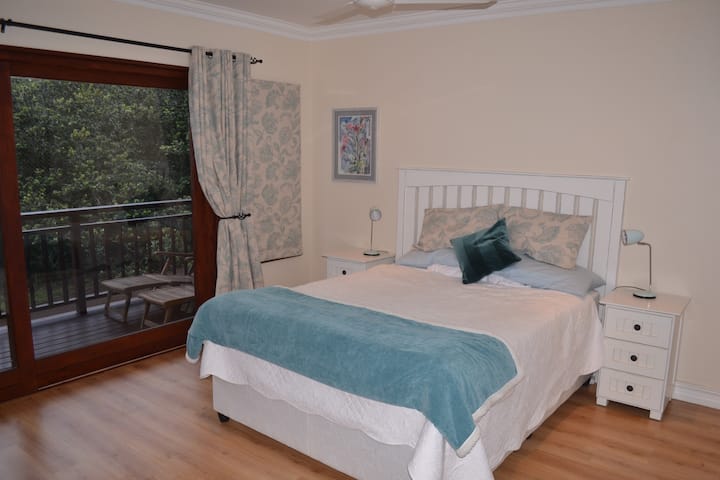 Spacious main bedroom, x-length queen bed with en suite, private deck and view