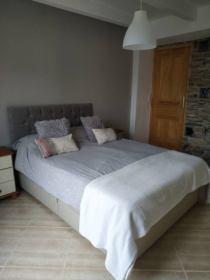 Bedroom 2 with stone wall
