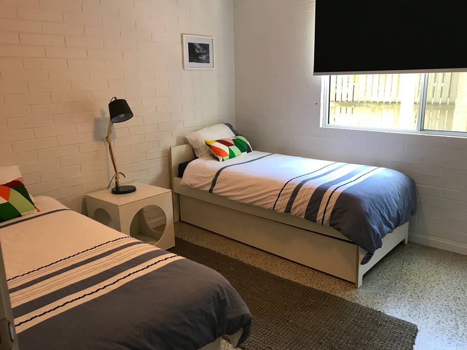 Second bedroom with two singles. Also has ceiling fan, built in robes and a desk.