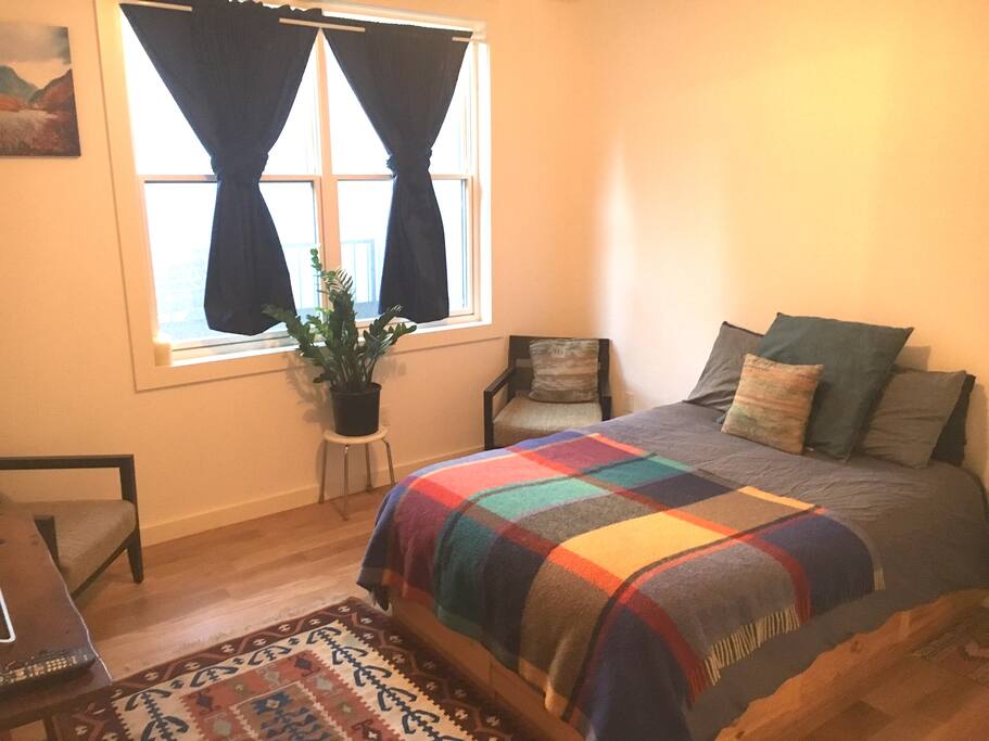 Cozy full bed with lots of natural light