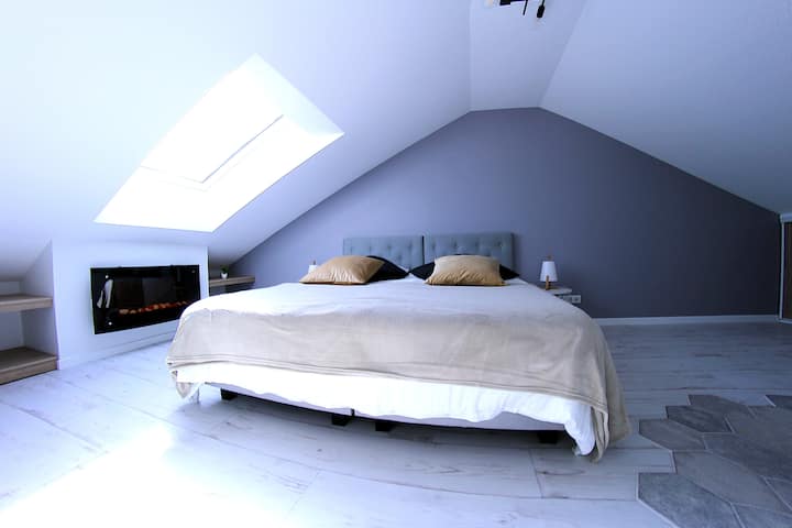 Upstairs bedroom with king-size bed and balneotherapy bathtub (possibility to make single beds on request)