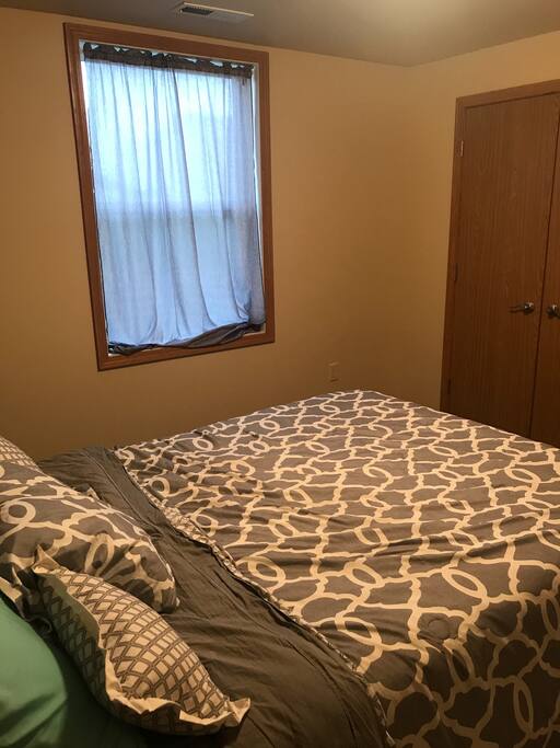 Cozy basement room, with egress window. Small bedroom closet.