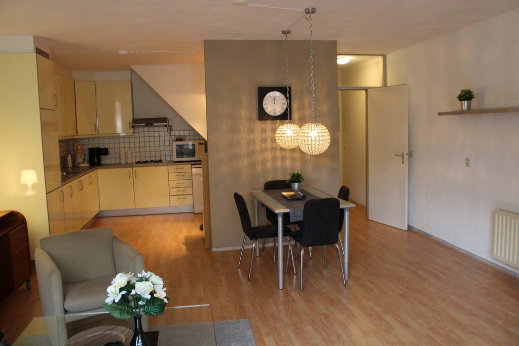 open kitchen with all equipment and dining table