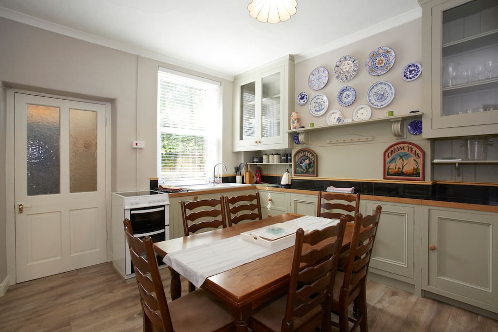 Bright sunny kitchen with built in dishwasher and laundry annex