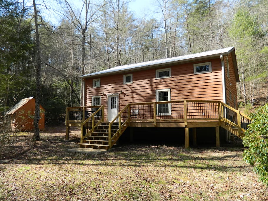 Front View of Cabin in Woods with Large Cleared Yard Area