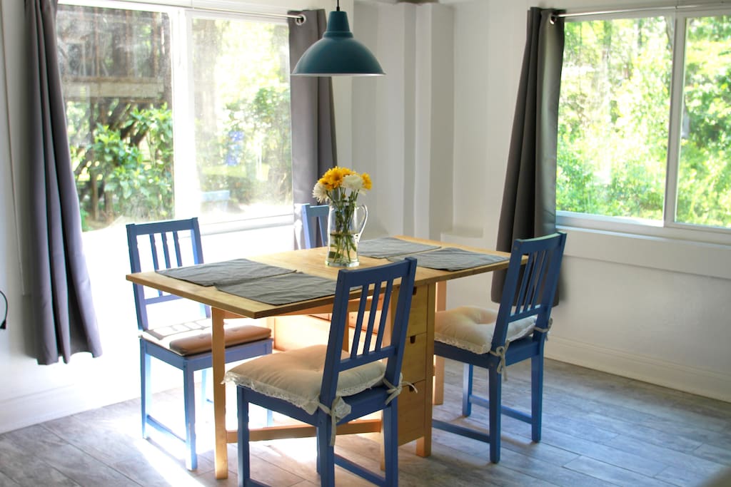 Fresh dining area with huge windows and plenty of natural light.