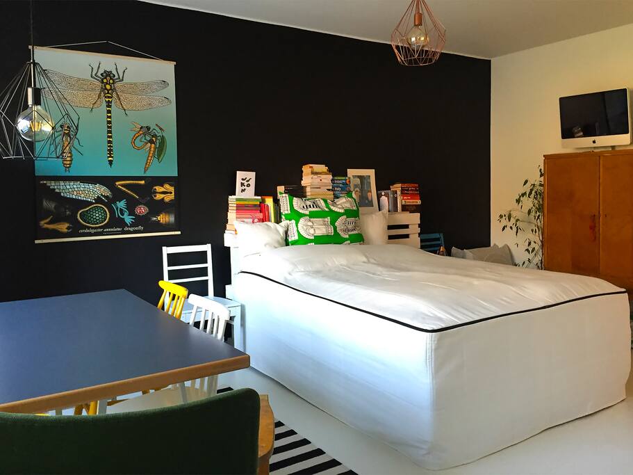 Double bed, small table area.