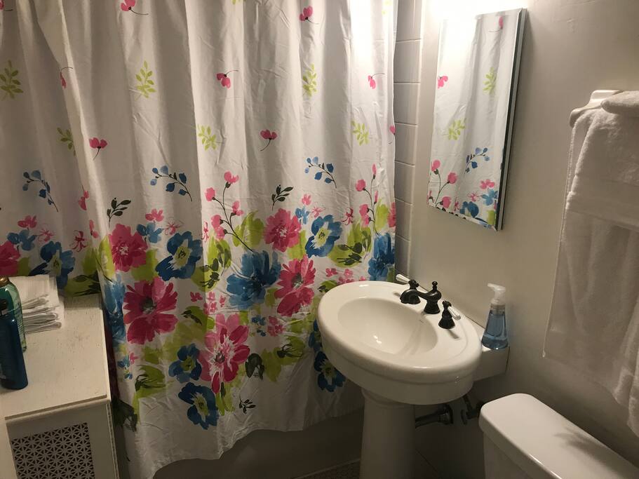 Beautiful white tile bathroom with cast iron tub/shower.