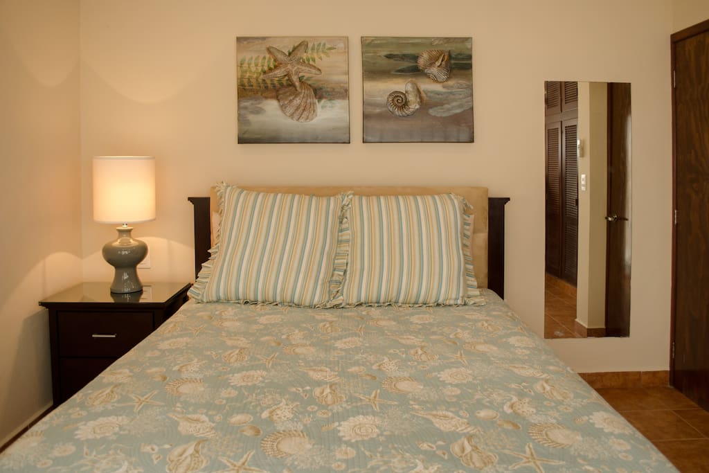 Luxurious queen guest bedroom with large closet, opens to vistas of the pool