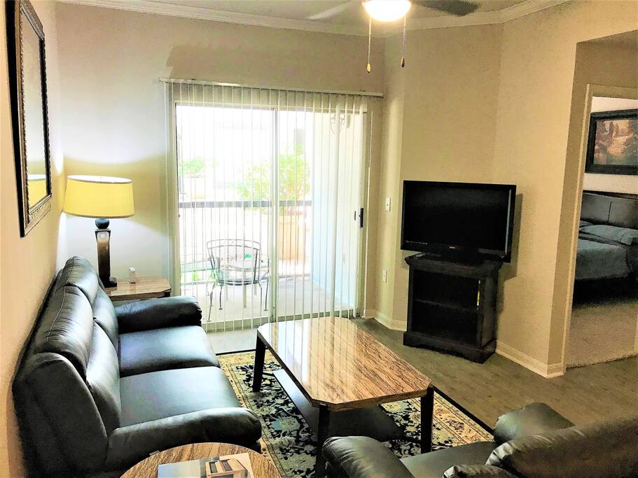 Living Room-Very spacious & includes TV with Netflix, AmazonTV, live TV & all movie channels (HBO, etc) via ATT App. New full-size comfy leather couch, sofa chair, & high speed 50mbps Wifi. Personal outdoor patio access with outdoor table and seating