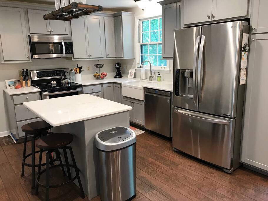 Newly renovated kitchen with new stainless steal appliances. Island with 2 bar stools.